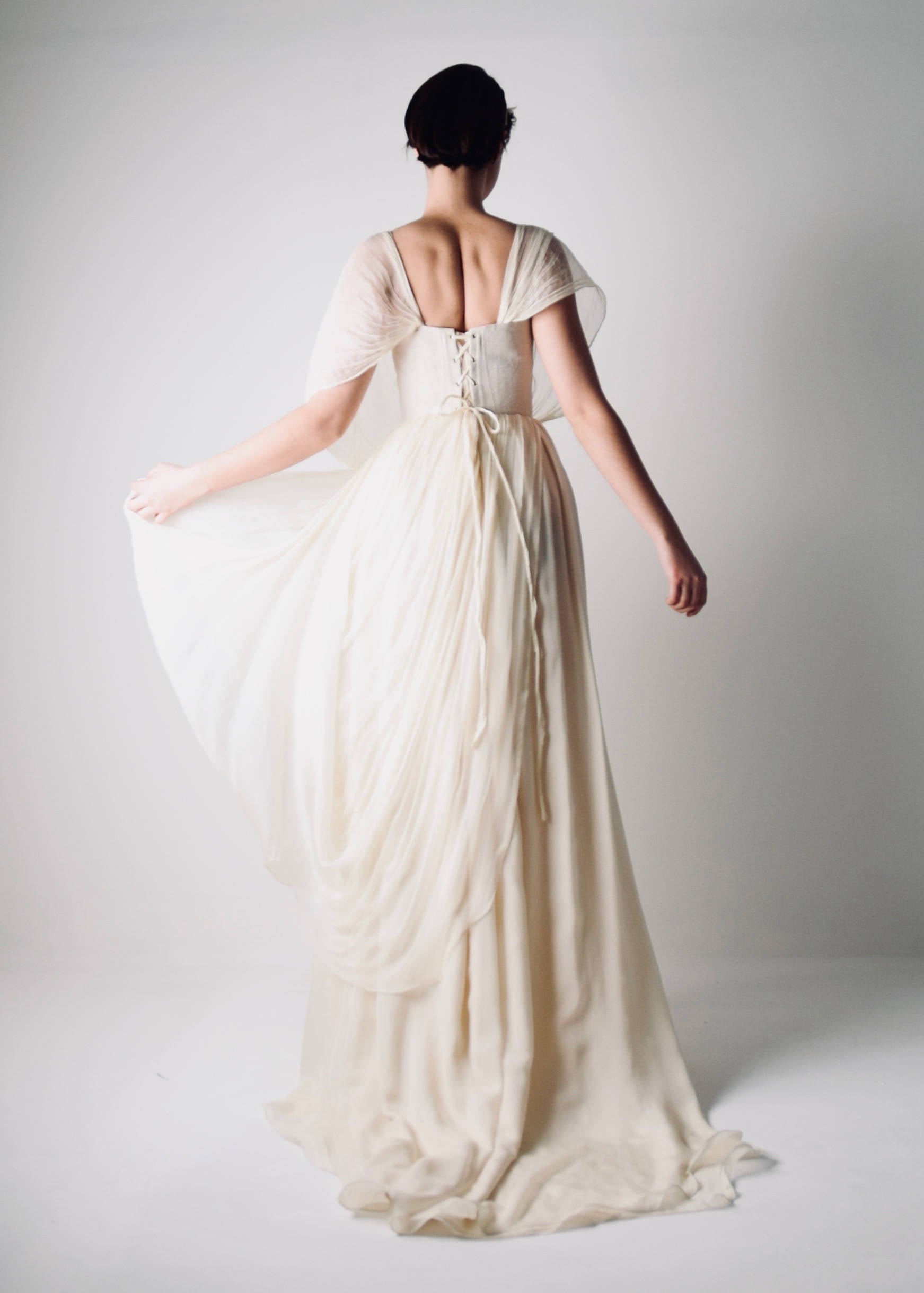 PAPAVER, a Grecian Wedding Dress in Flowing Chiffon, with sheer sleeves - back view movement