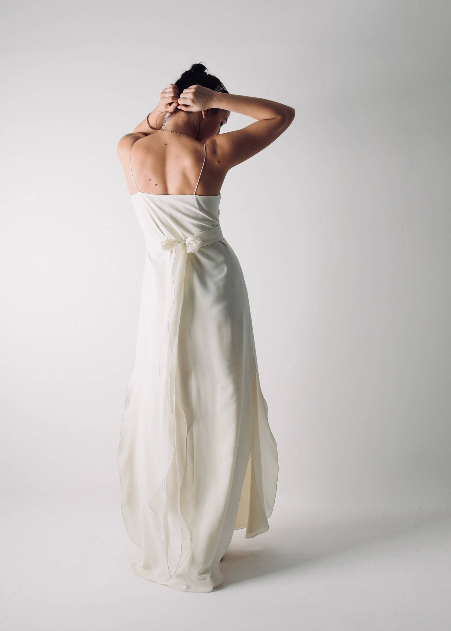 SAPONARIA, a Simple Slip Wedding Dress, with side slits and spaghetti straps, back view
