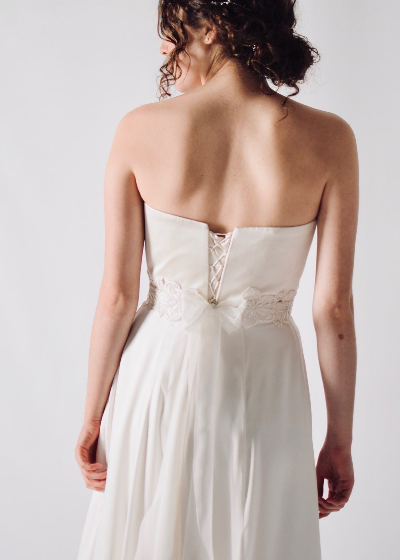 Daffodil, a floral lace bridal sash that closes with a soft silk bow in the back