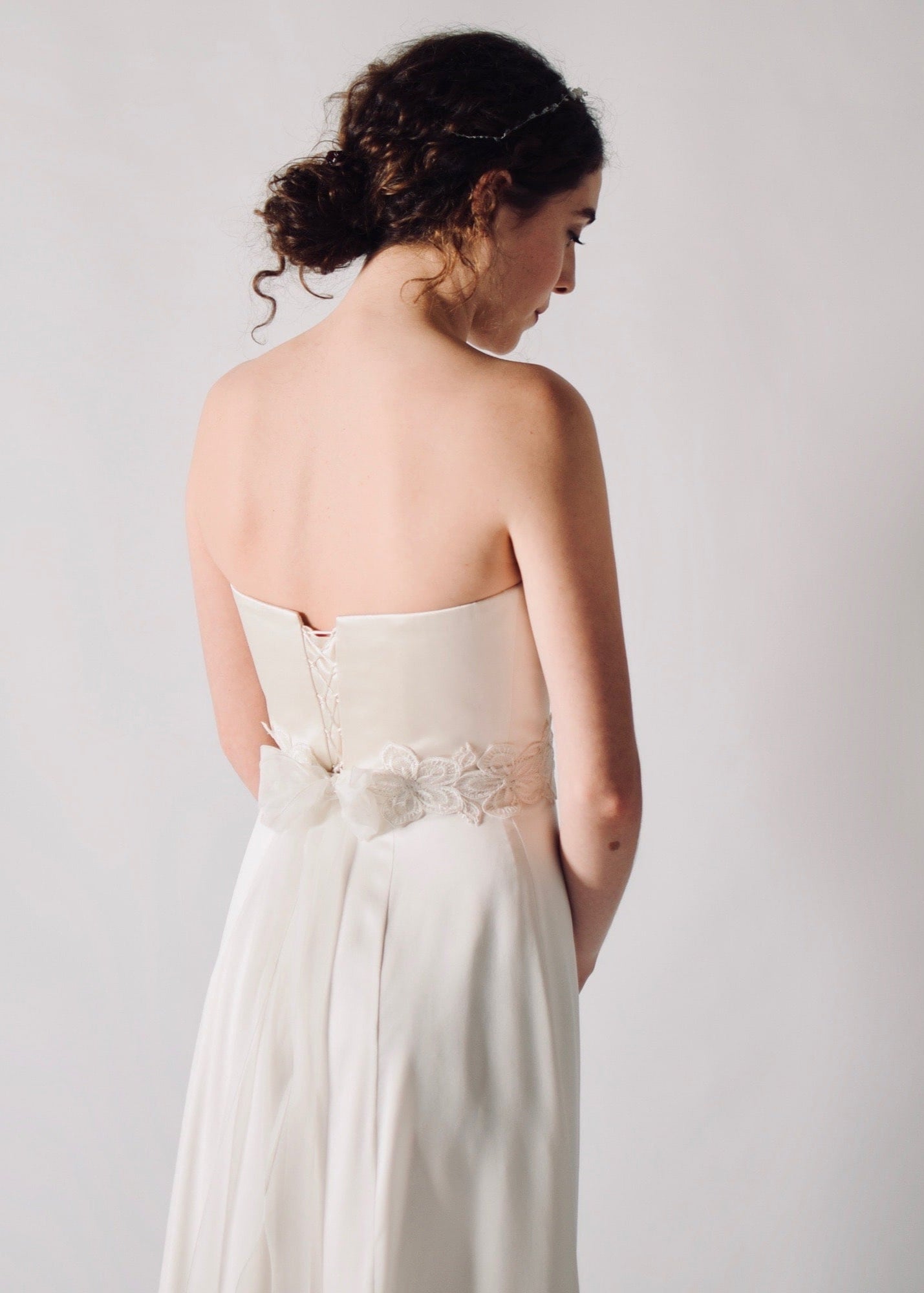 Daffodil, a floral lace bridal sash that closes with a soft silk bow in the back