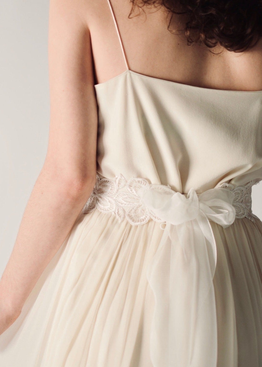 Daffodil, a floral lace bridal sash that closes with a soft silk bow in the back