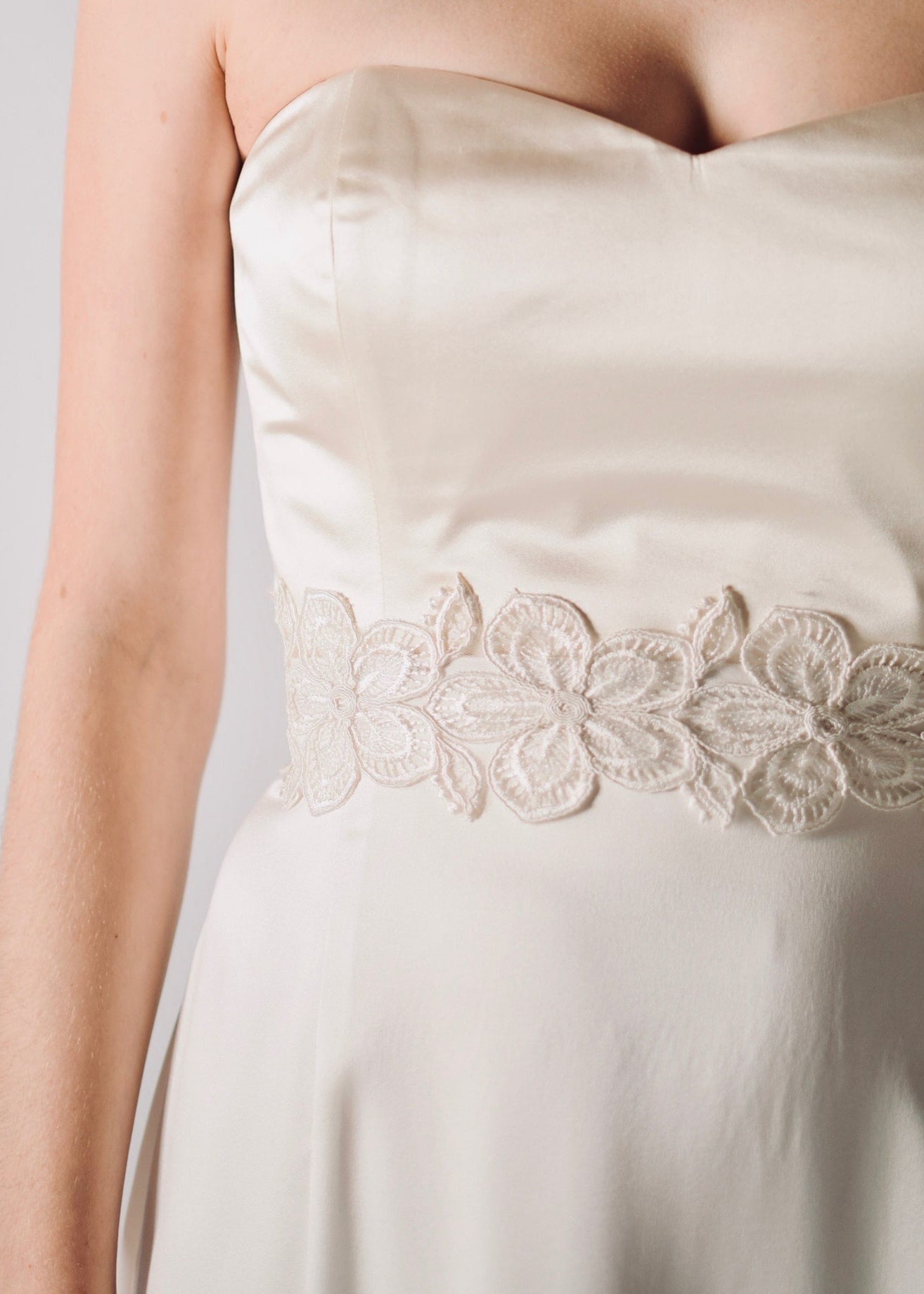 Daffodil, a floral lace bridal sash that closes with a soft silk bow in the back