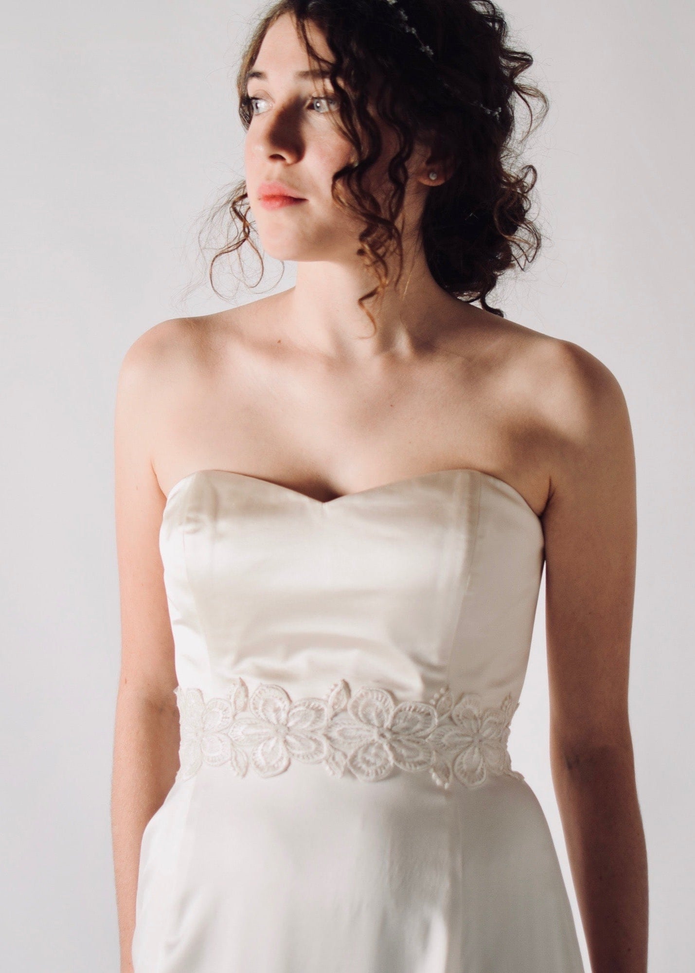 Daffodil, a floral lace bridal sash that closes with a soft silk bow in the back