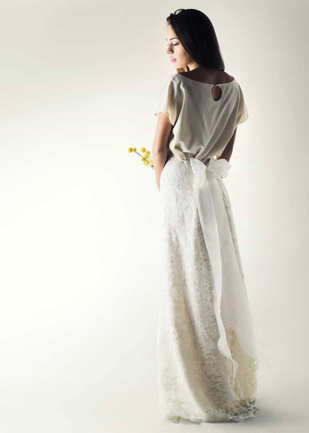 Romantic lace wedding skirt, with an A-line cut, paired with a separate soft silk bridal blouse with a keyhole, for a simple wedding dress look. Back view