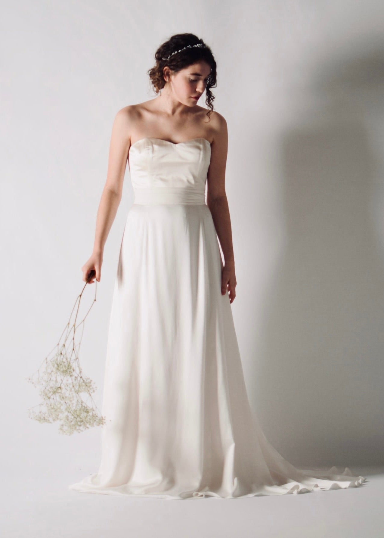 CALLA, A-Line Silk Satin Bridal Skirt with a Short Train, paired with a satin bustier with a sweetheart neckline, front view