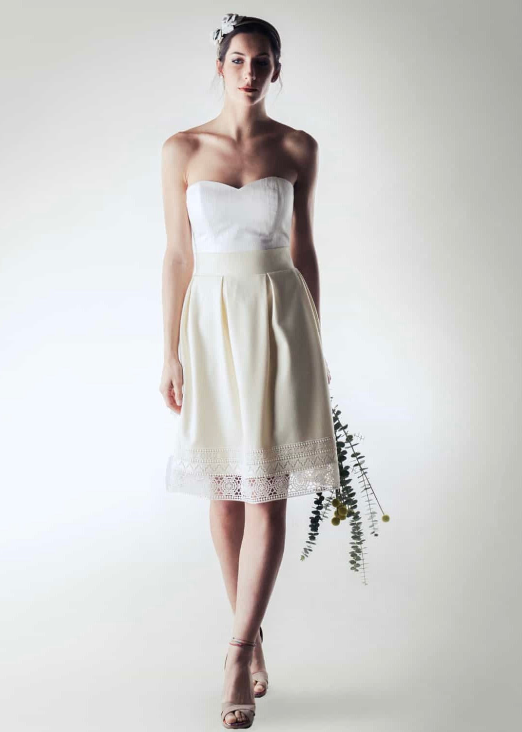 Pleated winter bridal look with an ivory crepe wool skirt, fully silk-lined and finished with a geometric cotton lace bottom edge