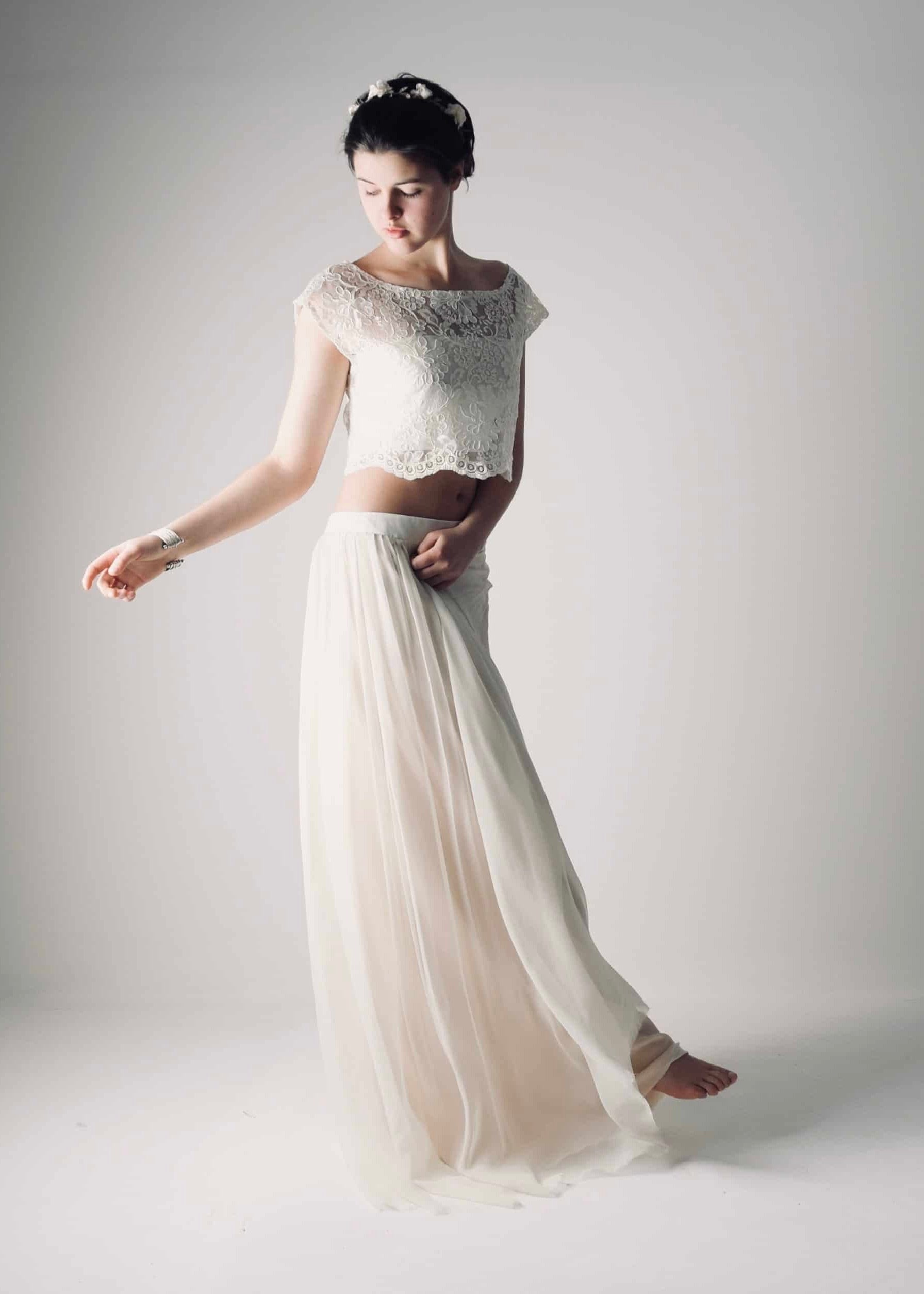 Movement view of a boho wedding dress with a lace crop top and flowing sheer skirt, ideal for a hippie or alternative wedding.